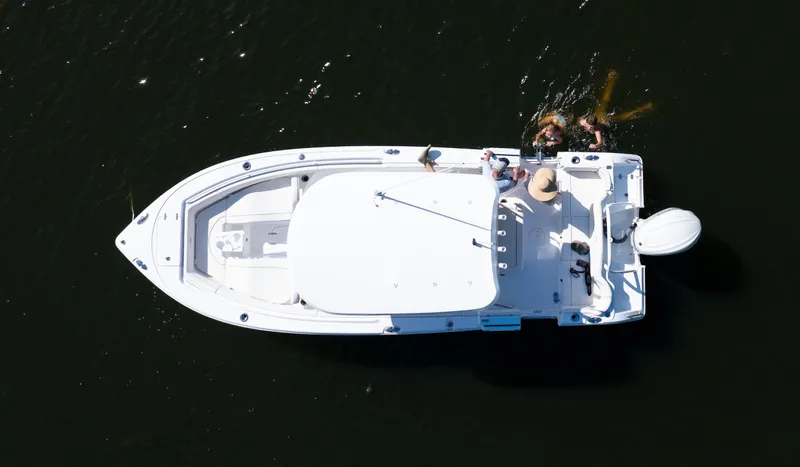 Slide: The Image of Aerial view of 2026 Sea Hunt Ultra 255 SE boat on water with people swimming nearby. - 24