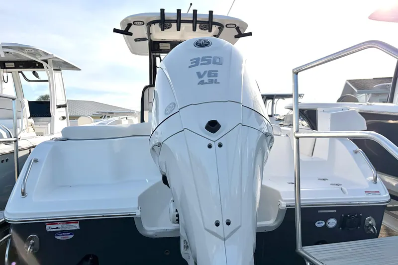 Slide: The Image of 2026 Sea Hunt Ultra 255 SE boat with powerful 350 V6 engine, docked outdoors. - 3