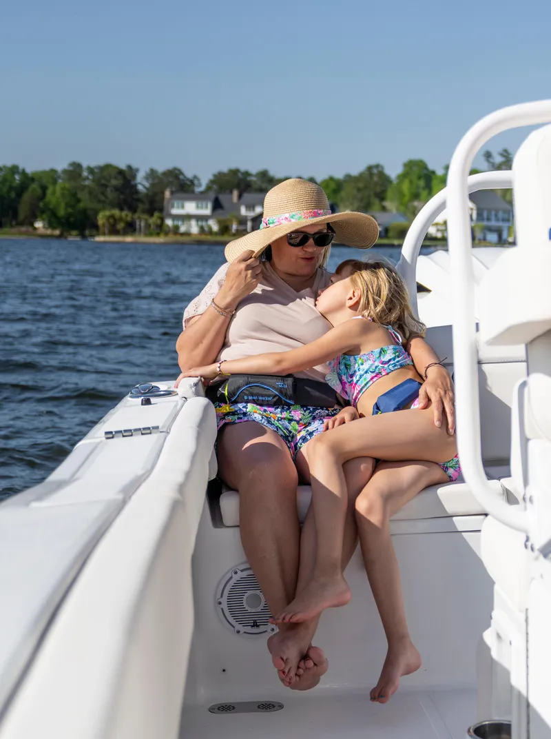 Slide: The Image of Grandmother and child relaxing on a 2026 Sea Hunt Ultra 255 SE boat. - 30