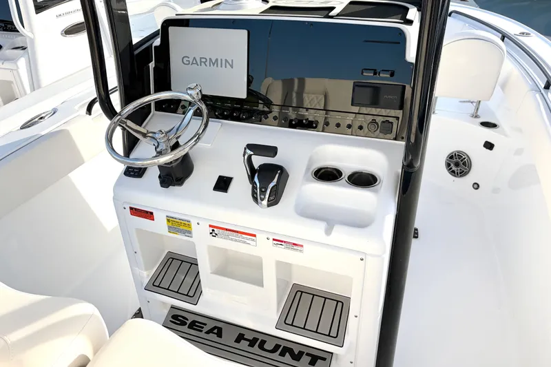 Slide: The Image of 2026 Sea Hunt Ultra 255 SE boat console with Garmin navigation system and steering wheel. - 4