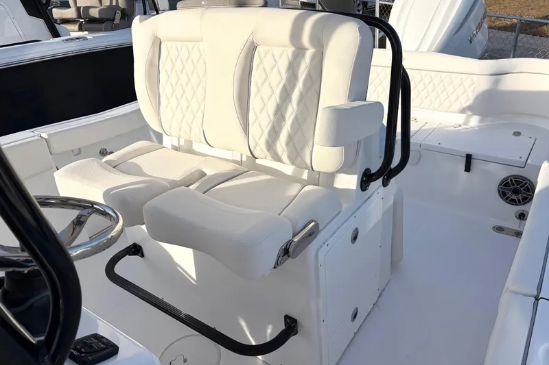 Slide: The Image of 2026 Sea Hunt Ultra 255 SE boat interior with white cushioned seating. - 6