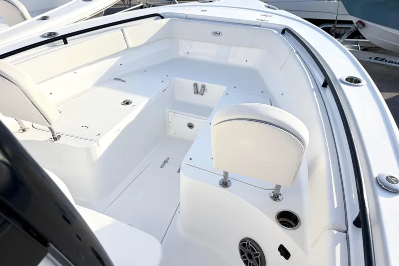 Slide: The Image of 2026 Sea Hunt Ultra 255 SE boat interior with white seating and storage compartments. - 7