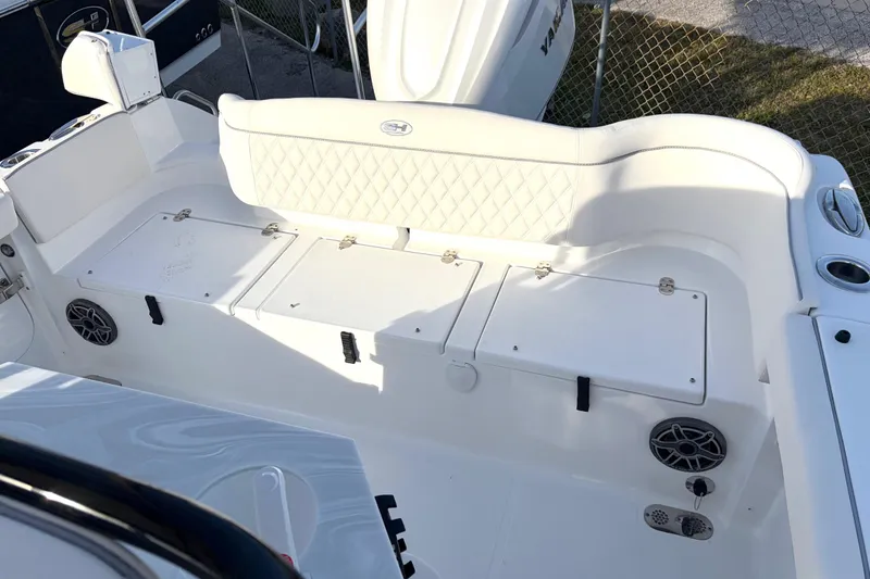 Slide: The Image of 2026 Sea Hunt Ultra 255 SE boat interior with white seating and storage compartments. - 8