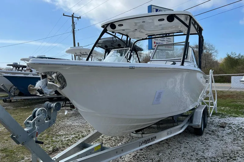 The Image of 2026 Sea Pro 240 Dual Console boat on trailer, displayed outdoors. - 1