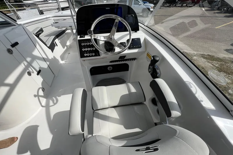 Slide: The Image of 2026 Sea Pro 240 Dual Console boat interior with steering wheel and seating. - 12