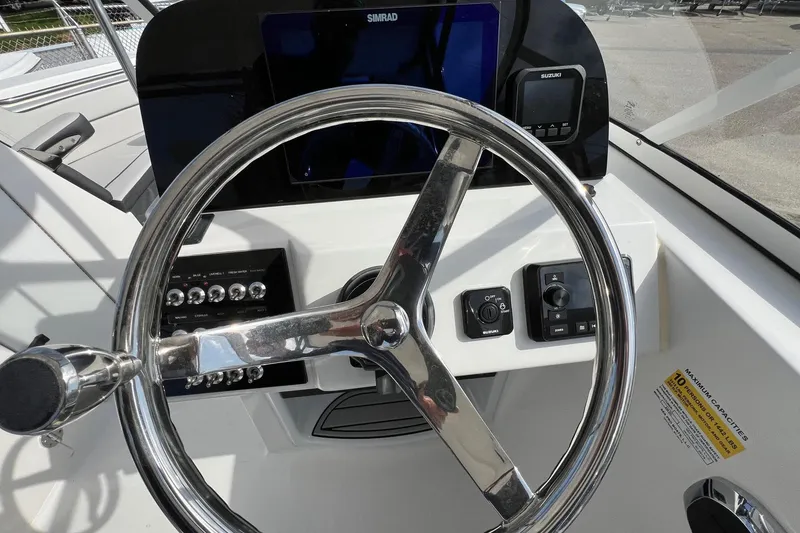 Slide: The Image of Steering wheel and controls of 2026 Sea Pro 240 Dual Console boat. - 14