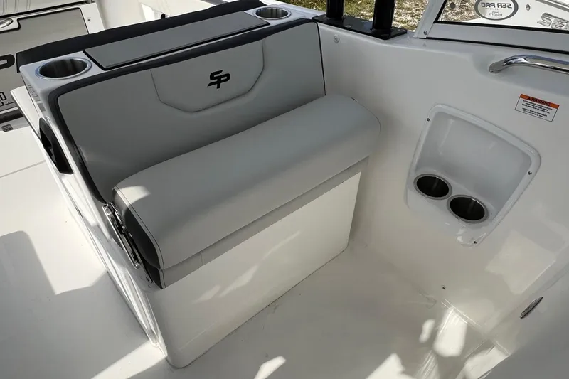 Slide: The Image of 2026 Sea Pro 240 Dual Console boat interior with seating and cup holders. - 16