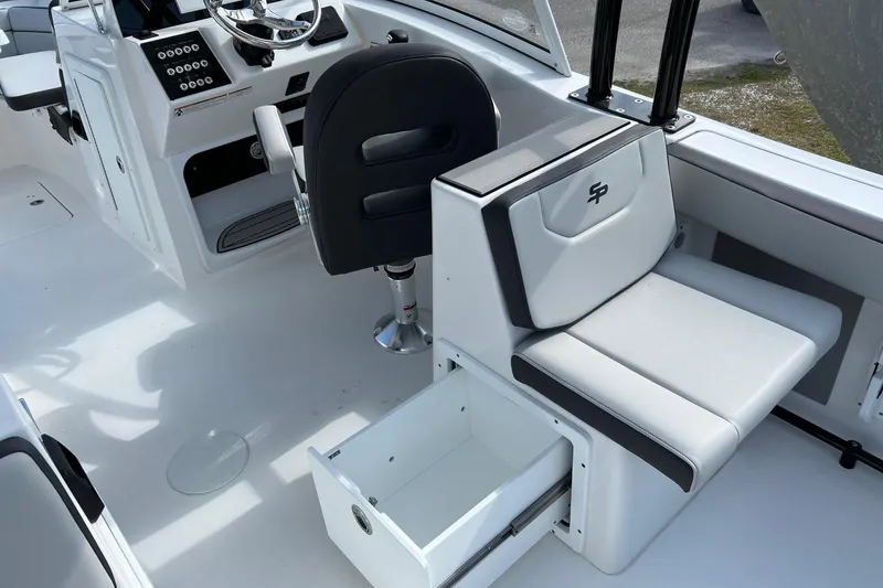Slide: The Image of 2026 Sea Pro 240 Dual Console interior with seating and storage drawer. - 18