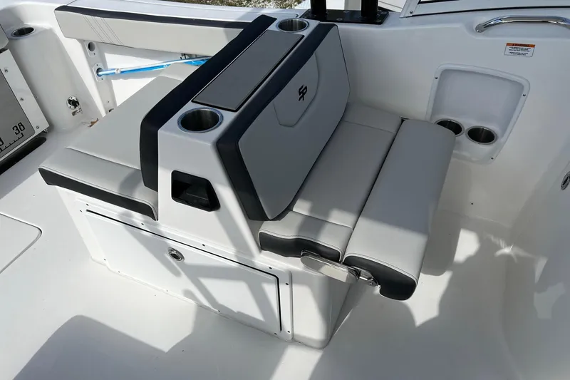 Slide: The Image of 2026 Sea Pro 240 Dual Console boat seating with cup holders and storage compartment. - 20
