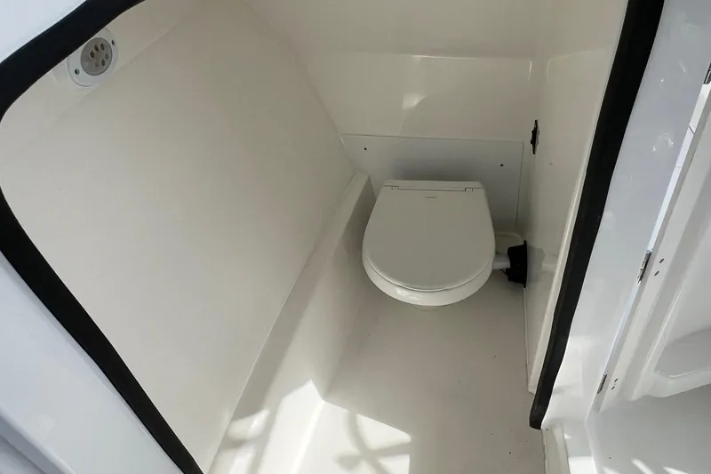 Slide: The Image of Interior view of 2026 Sea Pro 240 Dual Console boat's compact bathroom. - 24
