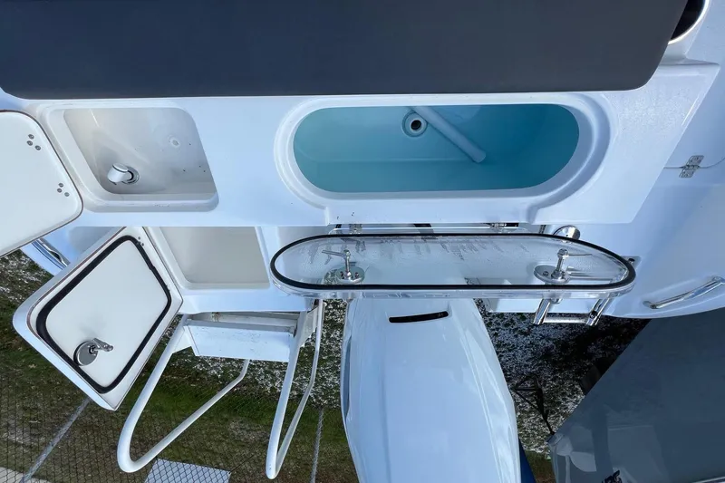 Slide: The Image of Interior view of 2026 Sea Pro 240 Dual Console boat with storage compartments. - 27