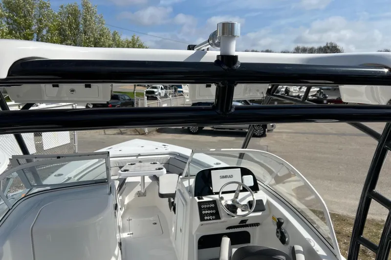 Slide: The Image of 2026 Sea Pro 240 Dual Console boat interior with steering wheel and seating. - 29