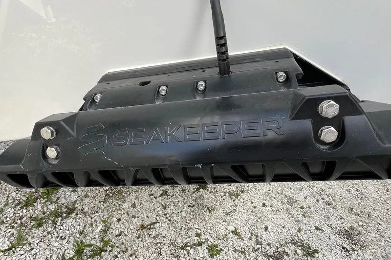 Slide: The Image of Seakeeper stabilizer on 2026 Sea Pro 240 Dual Console boat, mounted on gravel surface. - 35
