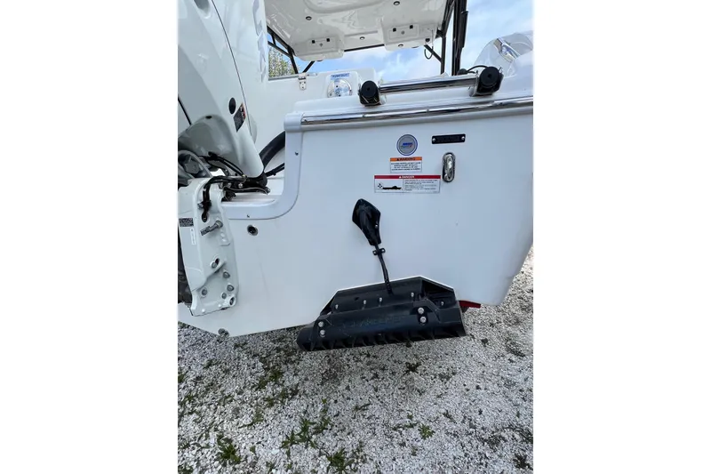 Slide: The Image of 2026 Sea Pro 240 Dual Console boat stern with trim tab and engine details. - 6
