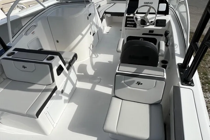 Slide: The Image of 2026 Sea Pro 240 Dual Console boat interior with seating and steering wheel. - 8