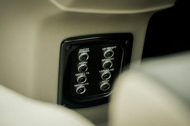 Slide: The Image of Control panel of Dockside 20DQ 2026 boat with labeled switches. - 10