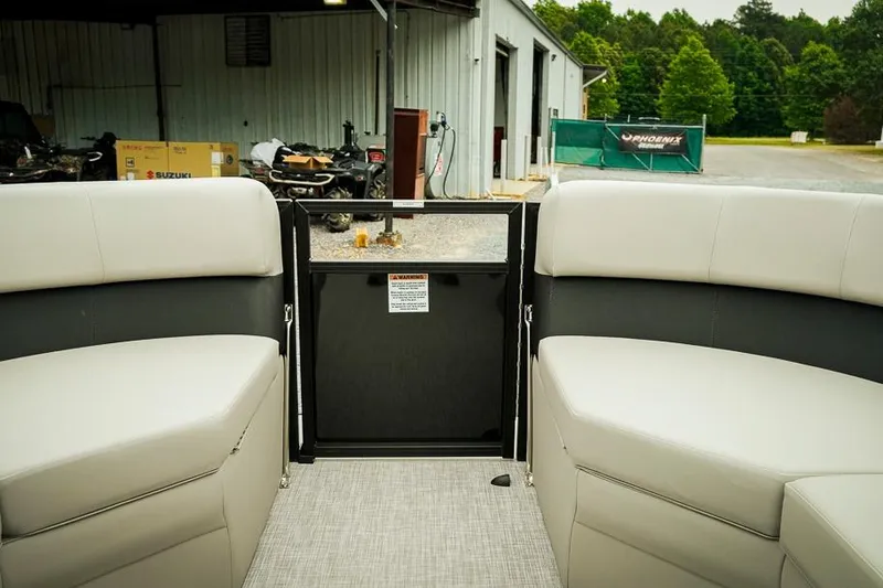 Slide: The Image of Interior view of 2026 Dockside 20DQ boat with cushioned seating and open gate. - 24