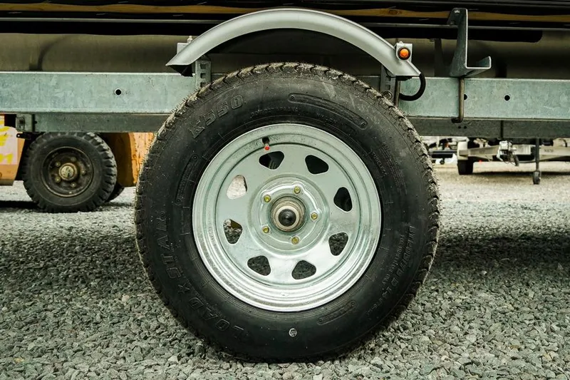 Slide: The Image of Trailer wheel of Dockside 20DQ 2026 model on gravel surface. - 28