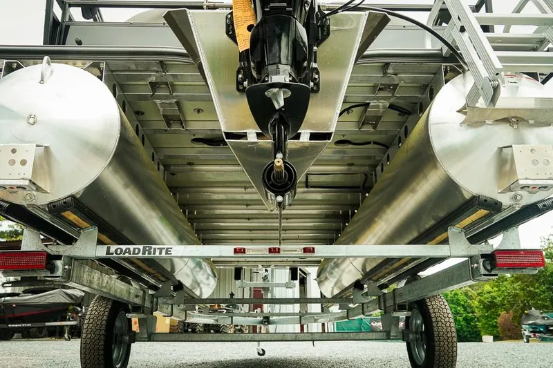 Slide: The Image of Underneath view of a 2026 Dockside 20DQ pontoon boat on a LoadRite trailer. - 29