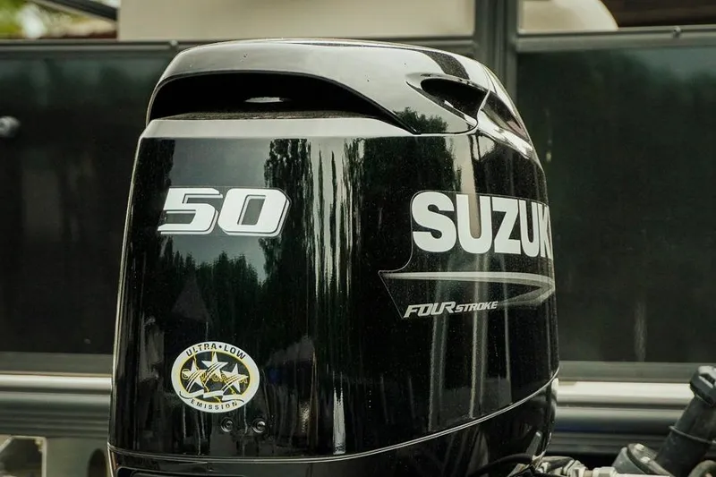 Slide: The Image of Suzuki 50 horsepower four-stroke outboard motor, ultra-low emission, on Dockside 20DQ, 2026 model. - 30