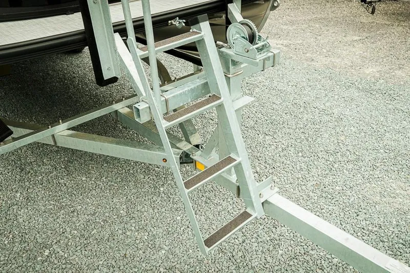 Slide: The Image of Metal ladder on Dockside 20DQ trailer, 2026 model, on gravel surface. - 5