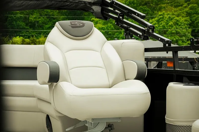 Slide: The Image of Luxurious white captain's chair on 2026 Dockside 20DQ boat, surrounded by lush greenery. - 6