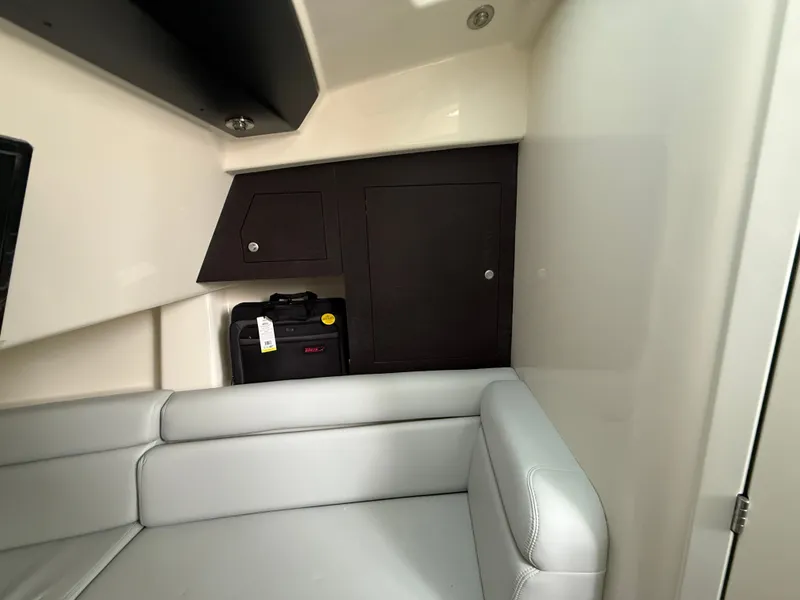 Slide: The Image of Interior of a 2027 Boston Whaler 350 Realm with gray upholstery and storage space. - 20
