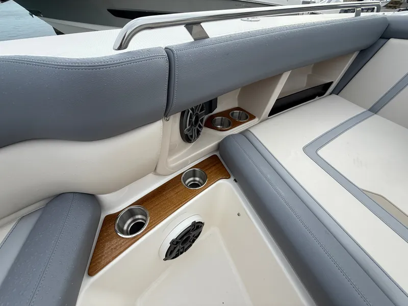 Slide: The Image of The 2027 Boston Whaler 350 Realm features a sleek seating area with gray upholstery and cup holders. - 10