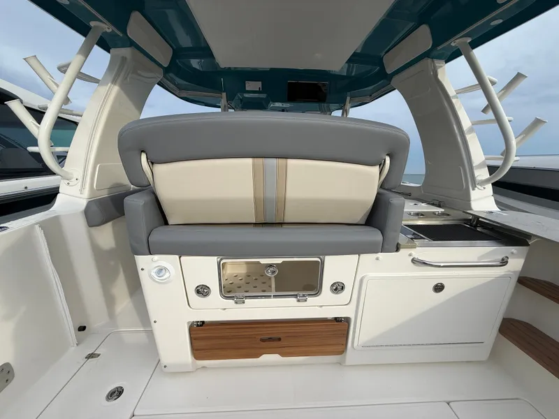 Slide: The Image of The image shows the cockpit of a 2027 Boston Whaler 350 Realm with gray and beige seating. - 31