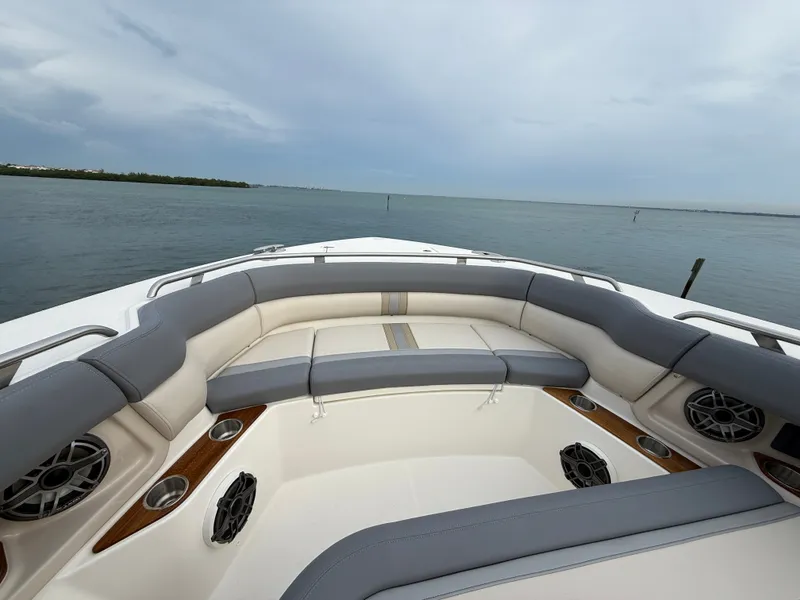 Slide: The Image of The image shows the bow area of a 2027 Boston Whaler 350 Realm with gray and white upholstery. - 7