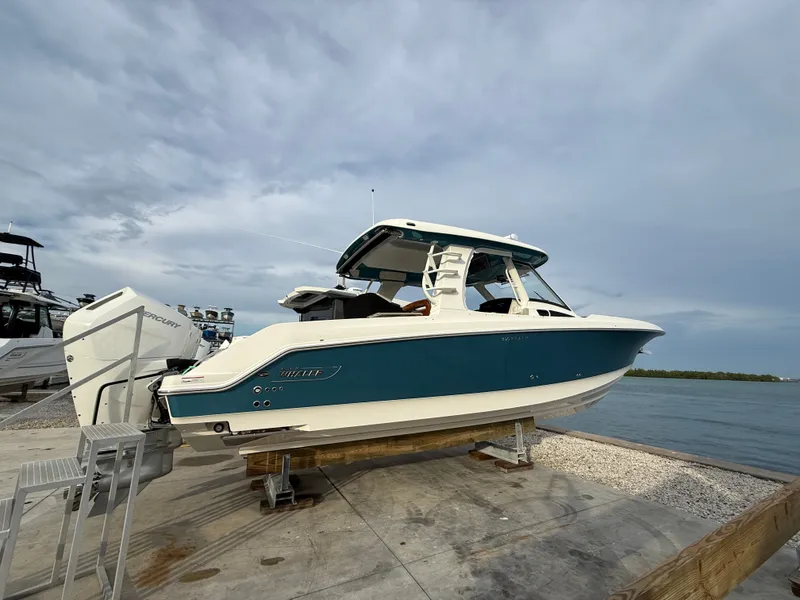 Slide: The Image of A 2027 Boston Whaler 350 Realm is docked, overlooking the water. - 1