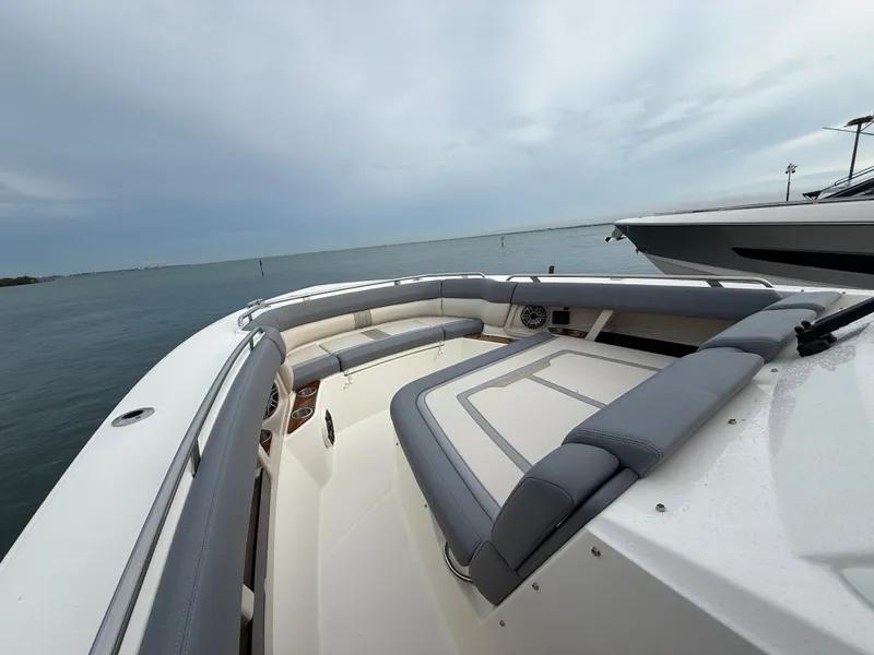 Slide: The Image of The image shows the spacious bow area of a 2027 Boston Whaler 350 Realm with gray cushions. - 6