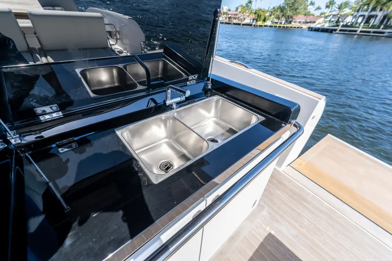 Slide: The Image of Outdoor kitchen on 2025 Solaris Power 44 Open yacht with dual sinks by the water. - 21