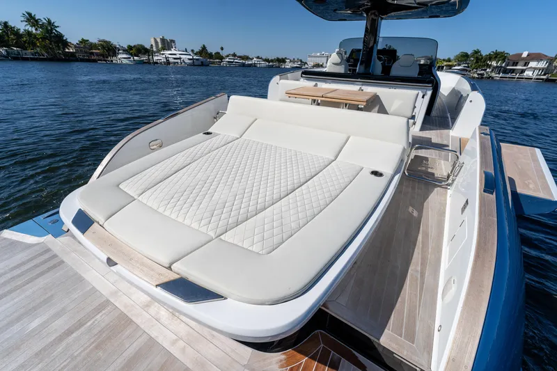 Slide: The Image of 2025 Solaris Power 44 Open yacht with luxurious sunbed on a serene waterway. - 27