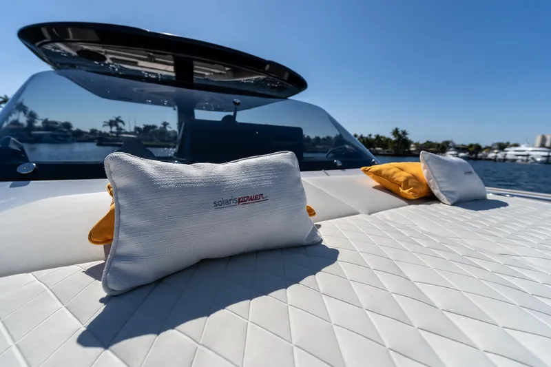 Slide: The Image of Luxurious Solaris Power 44 Open yacht deck with cushions, 2025 model, under clear blue sky. - 31