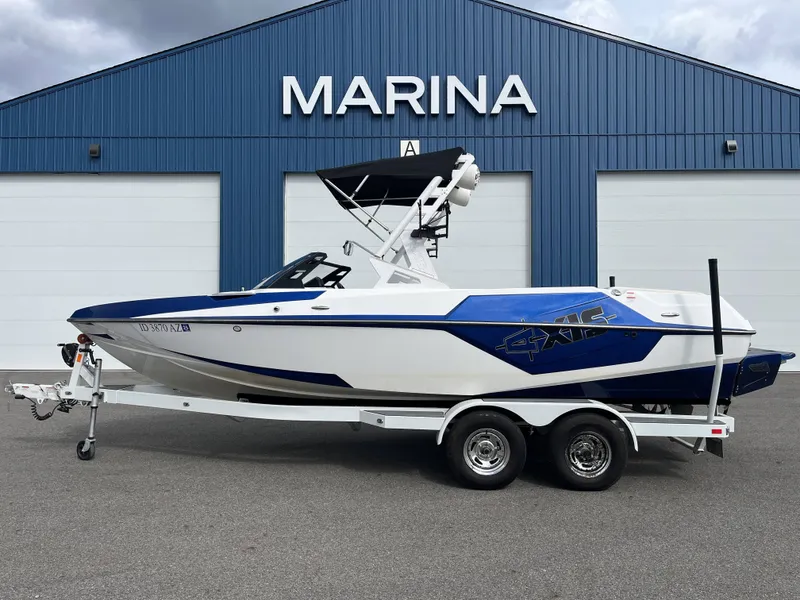 The Image of 2019 Axis T22 boat in front of blue marina. - 1