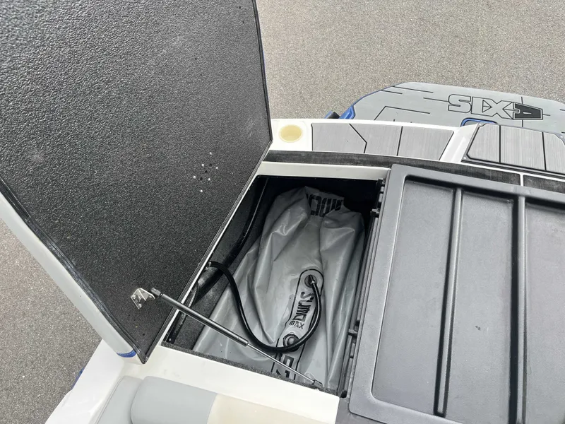 Slide: The Image of 2019 Axis T22 boat with open storage compartment lid. - 23