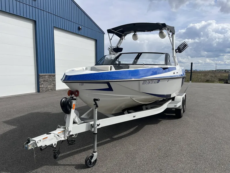 Slide: The Image of 2019 Axis T22 boat on trailer in front of blue building. - 3