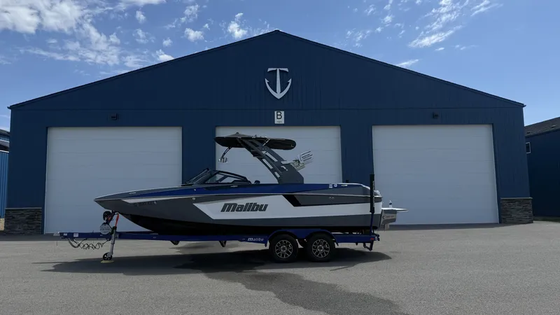 The Image of 2020 Malibu Wakesetter 23 MXZ in front of blue building. - 1