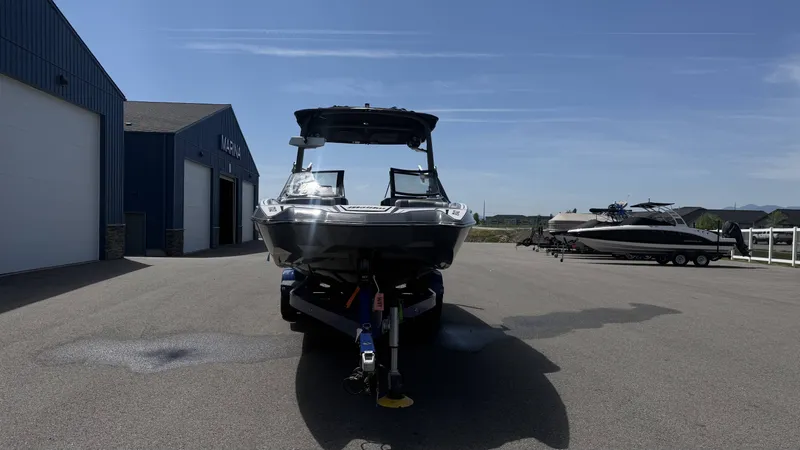 Slide: The Image of 2020 Malibu Wakesetter 23 MXZ in front of a marina. - 3
