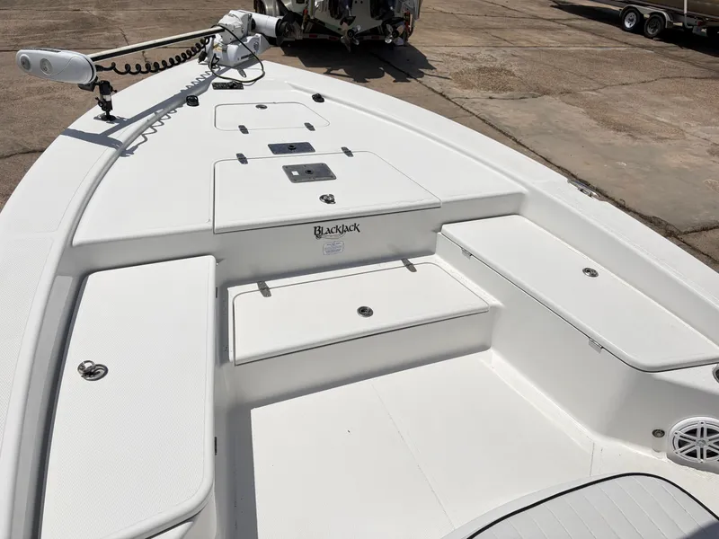 Slide: The Image of Deck of a 2011 BlackJack 224 boat with storage compartments. - 9