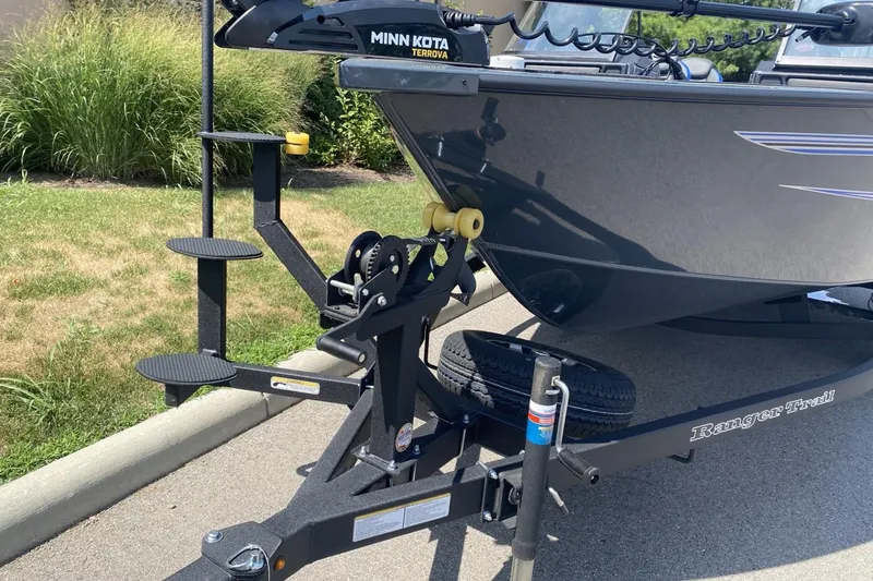 Slide: The Image of 2026 Ranger VX1788 WT boat on trailer with Minn Kota Terrova motor, parked on pavement. - 3