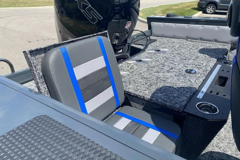 Slide: The Image of 2026 Ranger VX1788 WT boat interior with gray and blue seating, carpeted deck, and motor. - 8