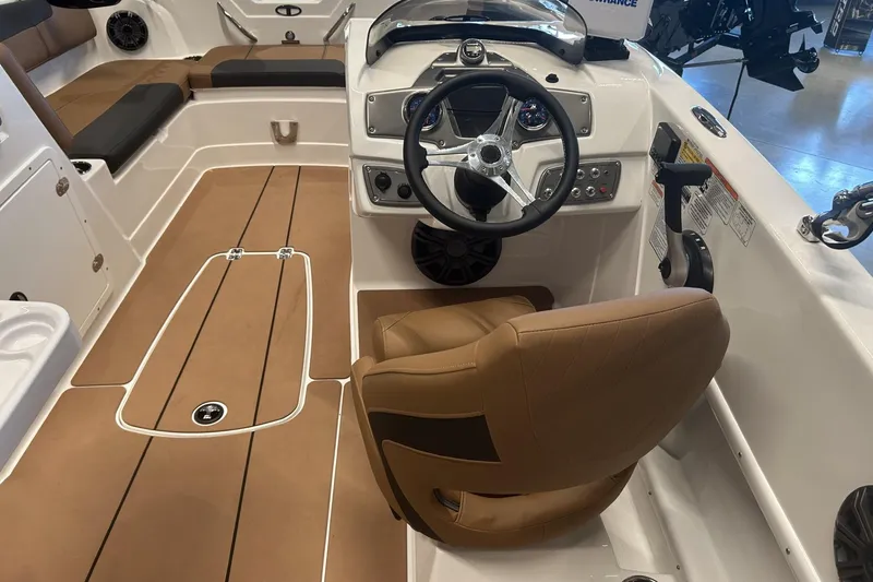 Slide: The Image of Interior of a 2026 Tahoe 1950 boat featuring a sleek steering console and brown seating. - 3