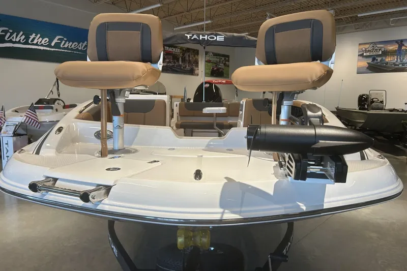 Slide: The Image of 2026 Tahoe 1950 boat interior with dual seats and modern design in showroom. - 1