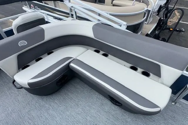 Slide: The Image of 2026 Sun Tracker Bass Buggy 18 DLX pontoon boat seating with cup holders and gray upholstery. - 8