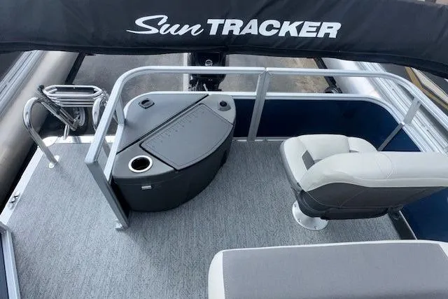 Slide: The Image of 2026 Sun Tracker Bass Buggy 18 DLX pontoon boat interior with seating and storage. - 10