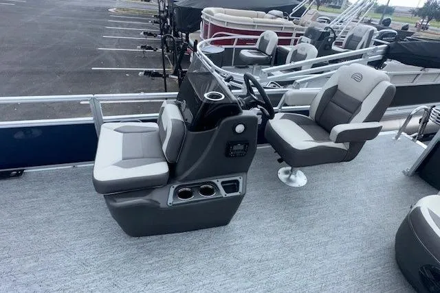 Slide: The Image of 2026 Sun Tracker Bass Buggy 18 DLX pontoon boat interior with dual seating and steering console. - 7