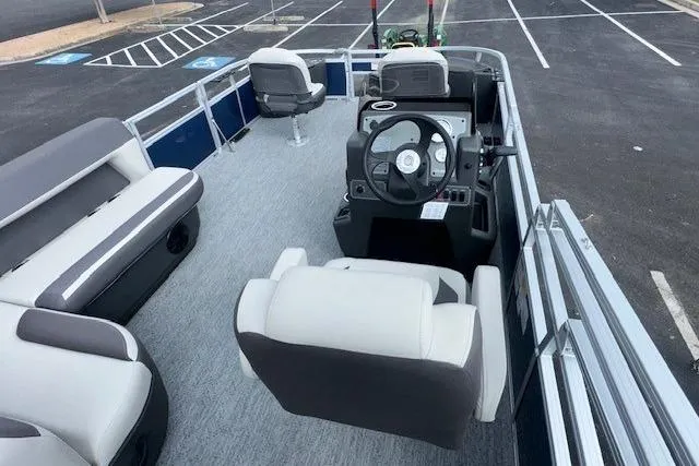Slide: The Image of 2026 Sun Tracker Bass Buggy 18 DLX pontoon boat interior with seating and steering console. - 6