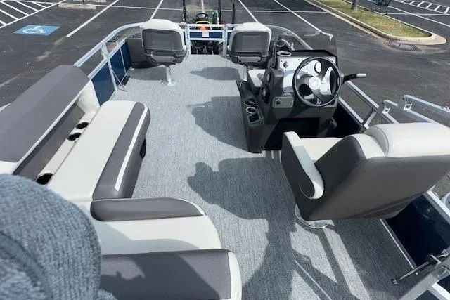 Slide: The Image of 2026 Sun Tracker Bass Buggy 18 DLX pontoon boat interior with seating and steering console. - 9